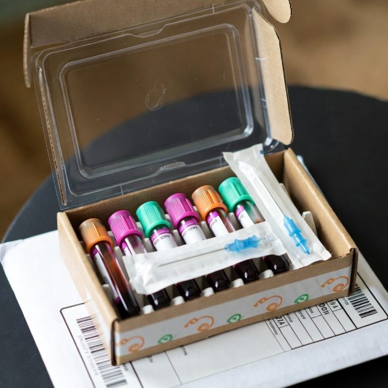 A box containing several vials and a syringe for medical use.